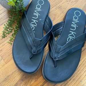 Black Calvin Klein flip flops